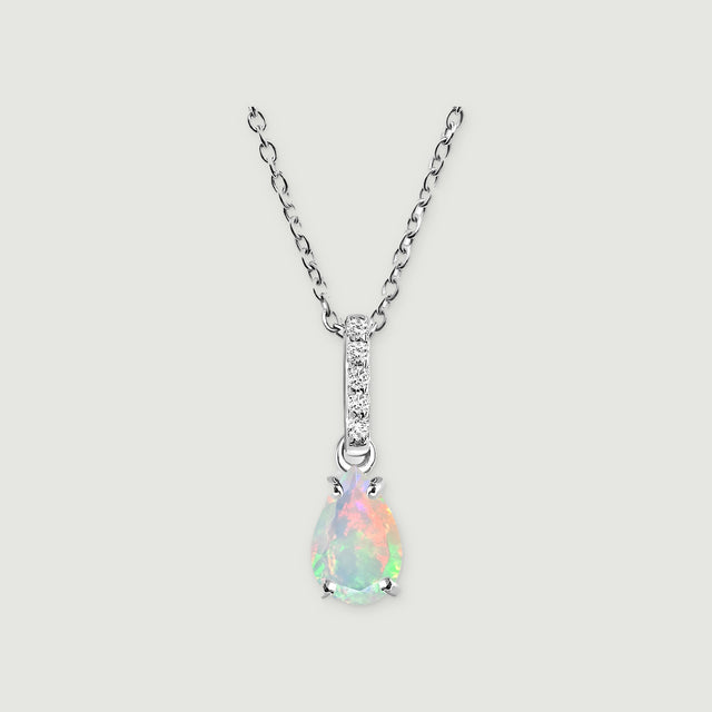 A silver chain meets a slim stone-set bail above a colorful teardrop opal on light gray.