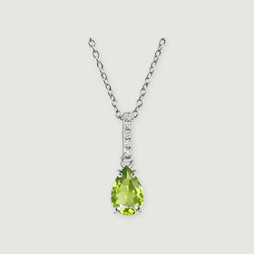 The sterling silver necklace has a faceted green pear pendant and a slim bail set with five white stones on light gray.