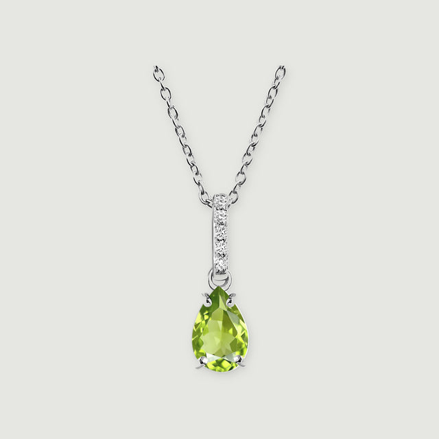The sterling silver necklace has a faceted green pear pendant and a slim bail set with five white stones on light gray.