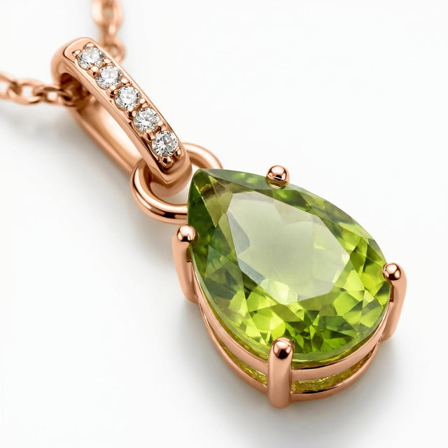 Rose gold prongs frame the pear-shaped peridot in an angled close-up with five white stones visible above it.