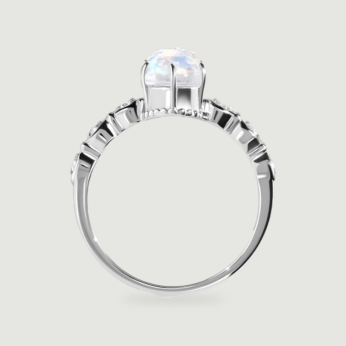 A white gold ring is shown from the side with an open setting beneath the faceted oval stone.