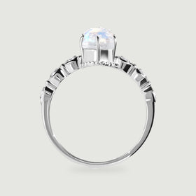 A white gold ring is shown from the side with an open setting beneath the faceted oval stone.