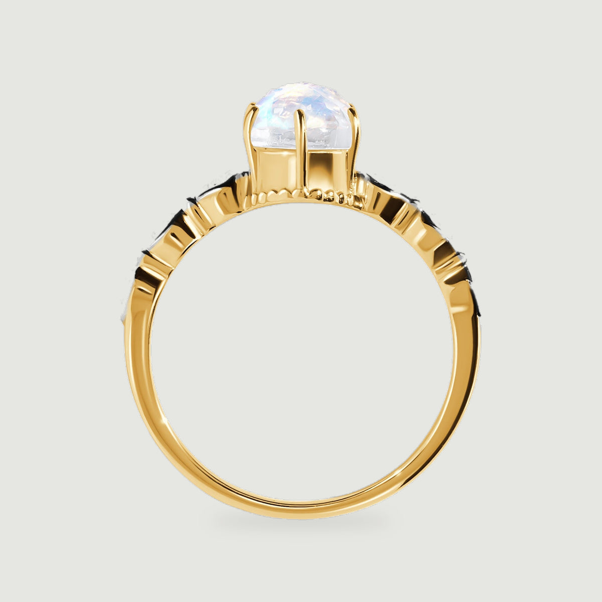 The yellow gold ring profile reveals slender prongs and diamond set shoulders around the oval stone.
