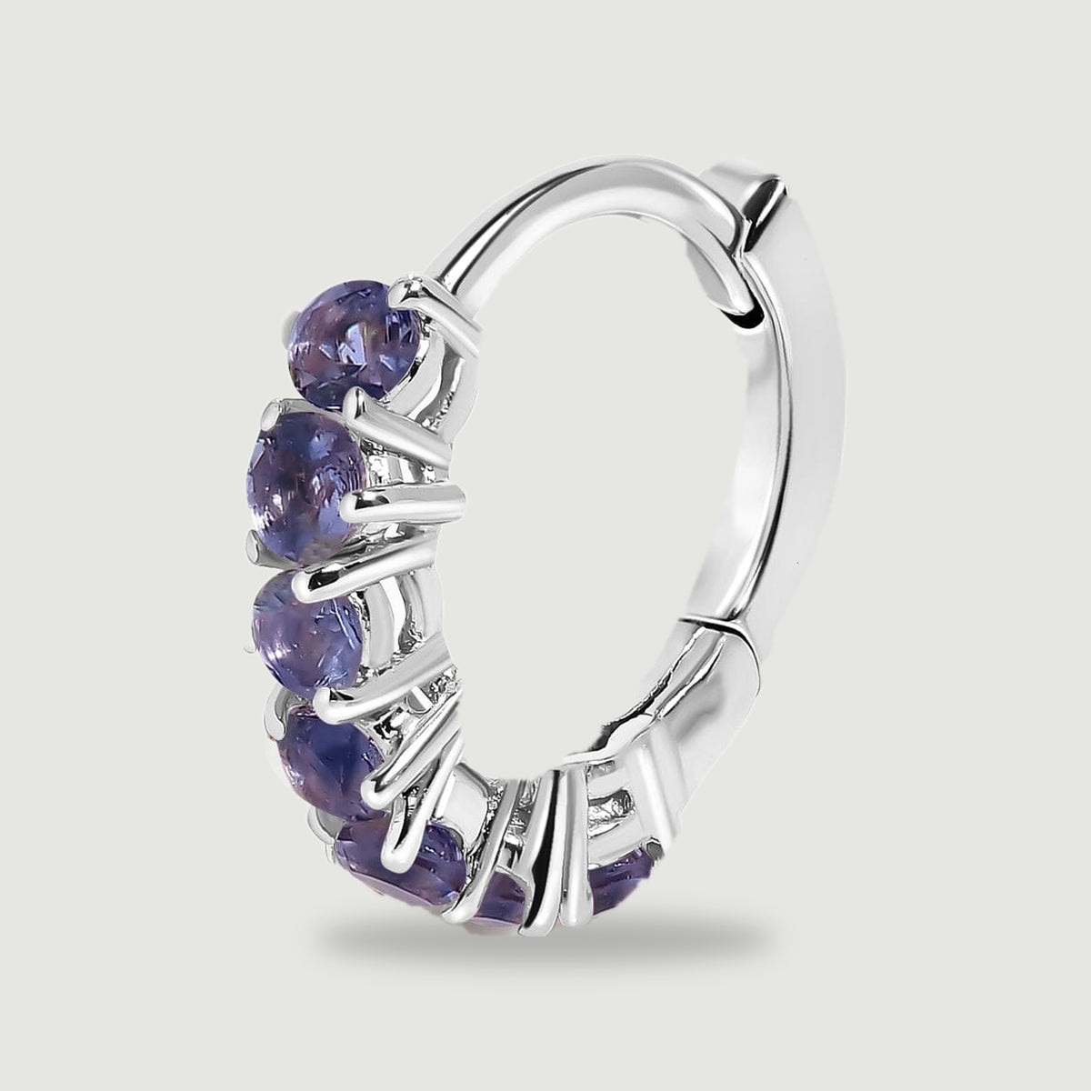 A single silver-tone hoop shows its violet stone row, curved back, and hinged closure.