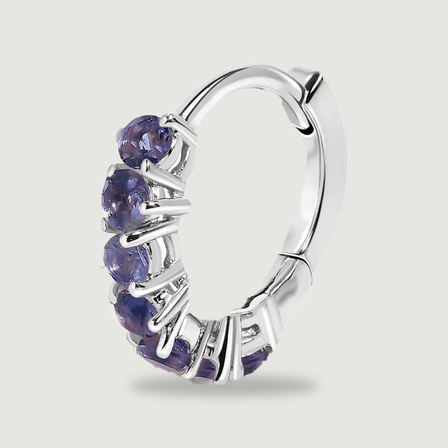 A single silver-tone hoop shows its violet stone row, curved back, and hinged closure.