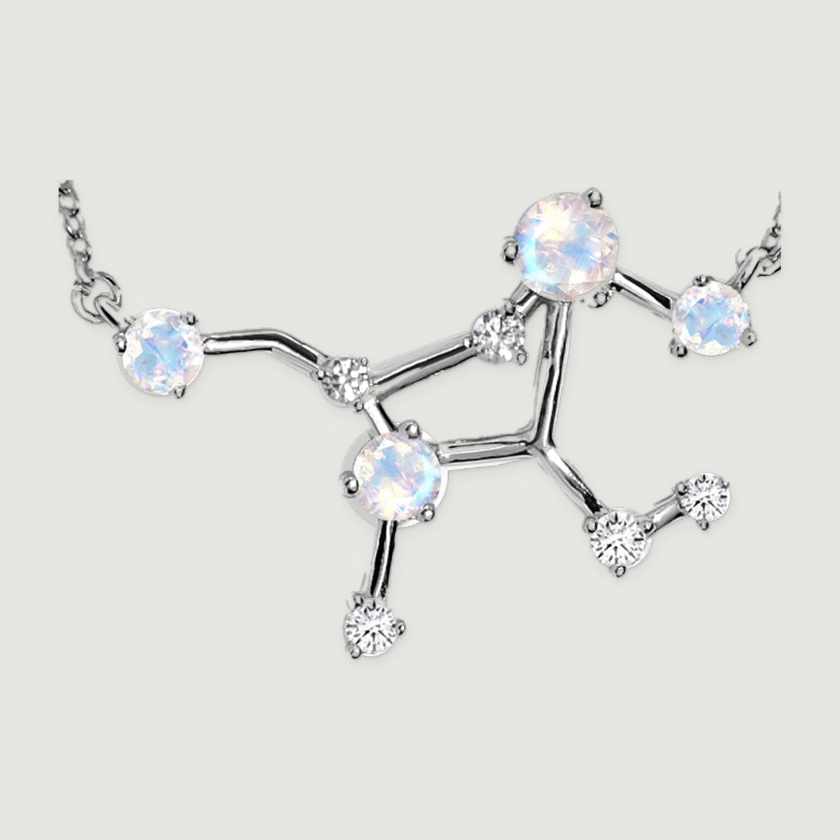 A close view shows the silver constellation centre with round iridescent stones, small clear stones and polished connecting bars.