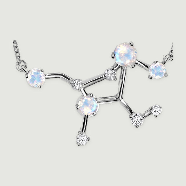 A close view shows the silver constellation centre with round iridescent stones, small clear stones and polished connecting bars.