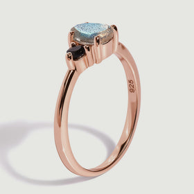The rose gold vermeil ring stands at an angle showing the prongs and the inside of its slender band.