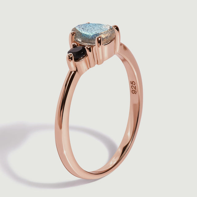 The rose gold vermeil ring stands at an angle showing the prongs and the inside of its slender band.