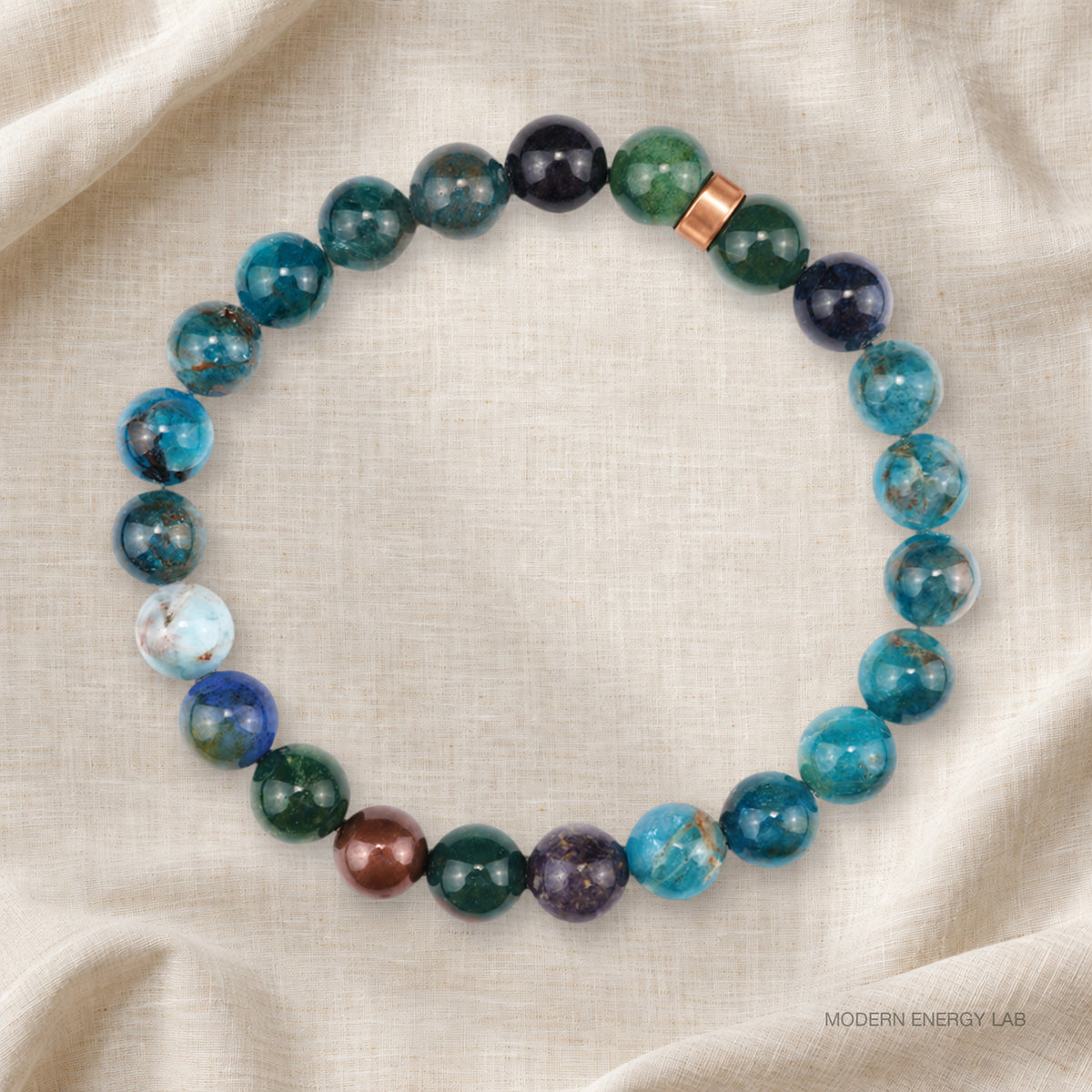 Full circle of blue-green natural stone beads with a smooth copper spacer on linen