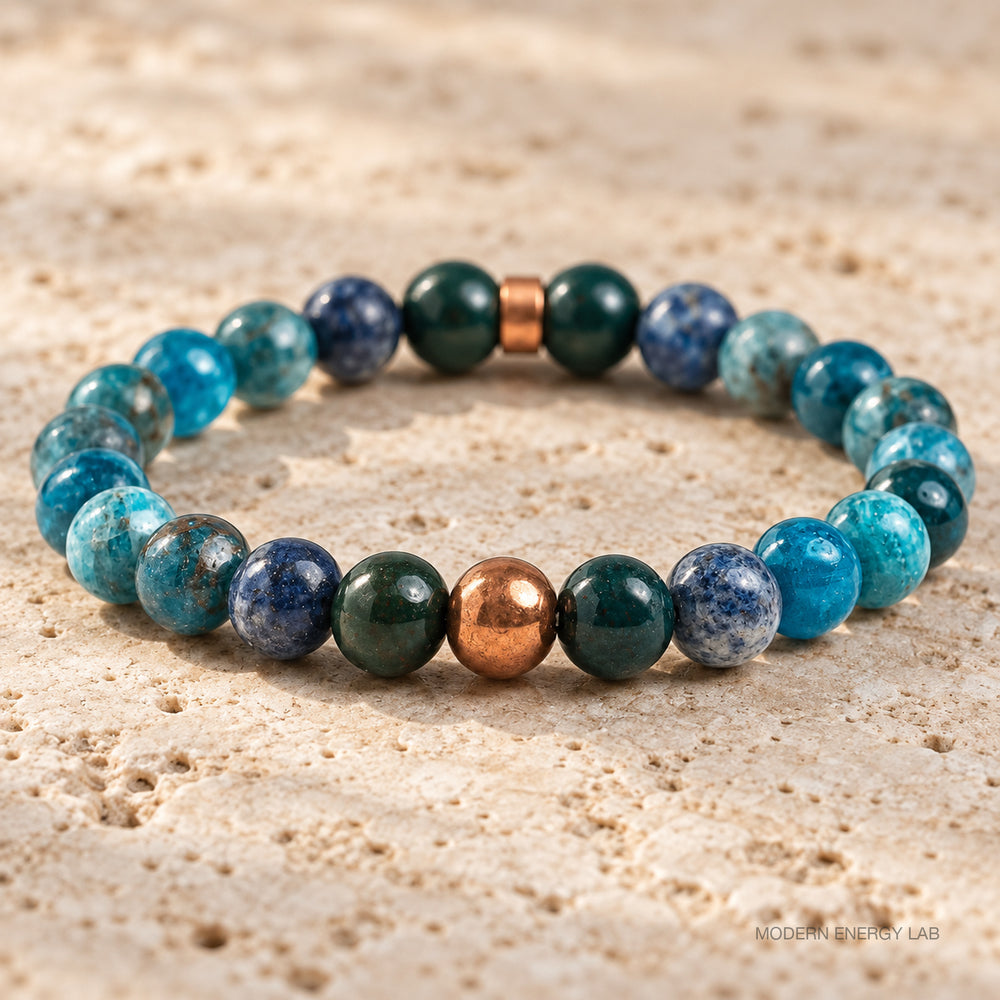 New close view of the copper round bead, bloodstone and blue apatite on travertine