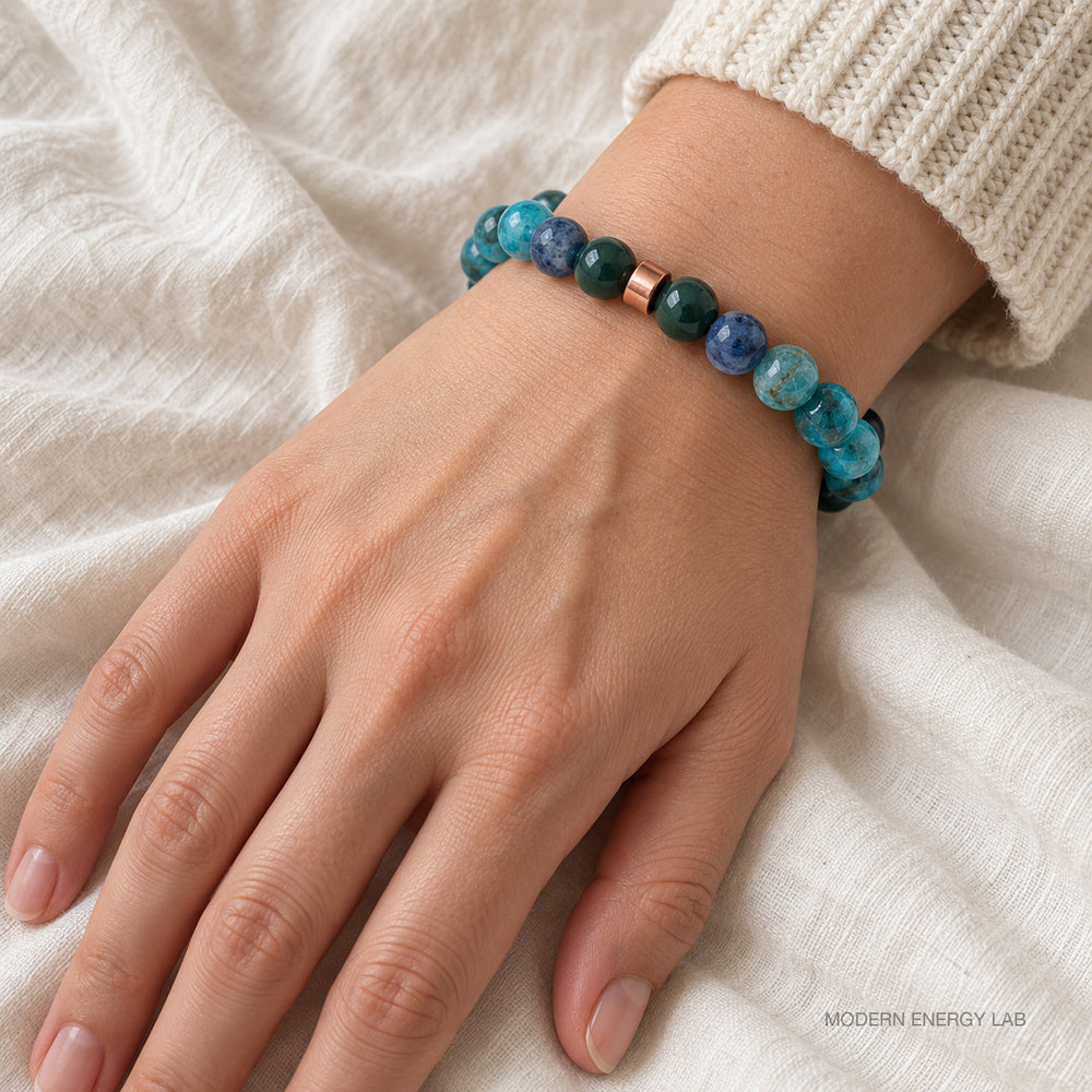 Blue-green natural stone bracelet worn with an ivory knit sleeve