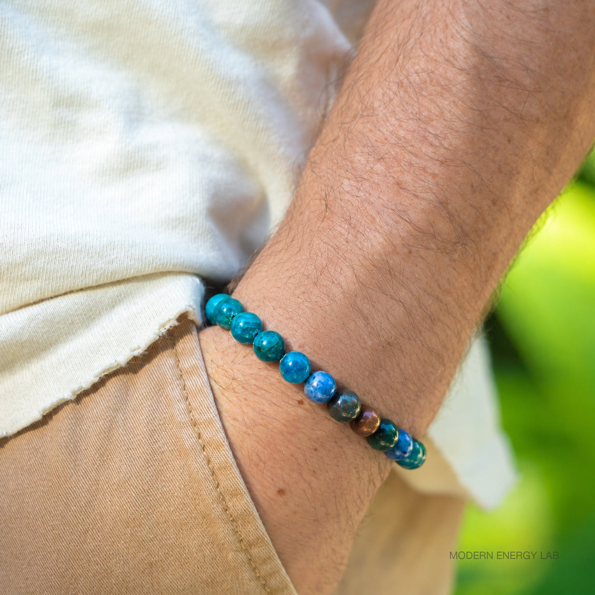 Single blue apatite, bloodstone and dumortierite bracelet on a wrist outdoors