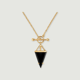 A yellow gold necklace with a black triangular pendant is centered on a light gray background.