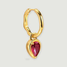 One yellow gold plated earring is shown at an angle with its curved hoop, hinge, and hanging red stone.