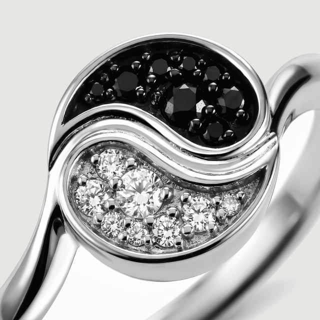 The silver toned curved divider separates clusters of black and clear stones in a close view.
